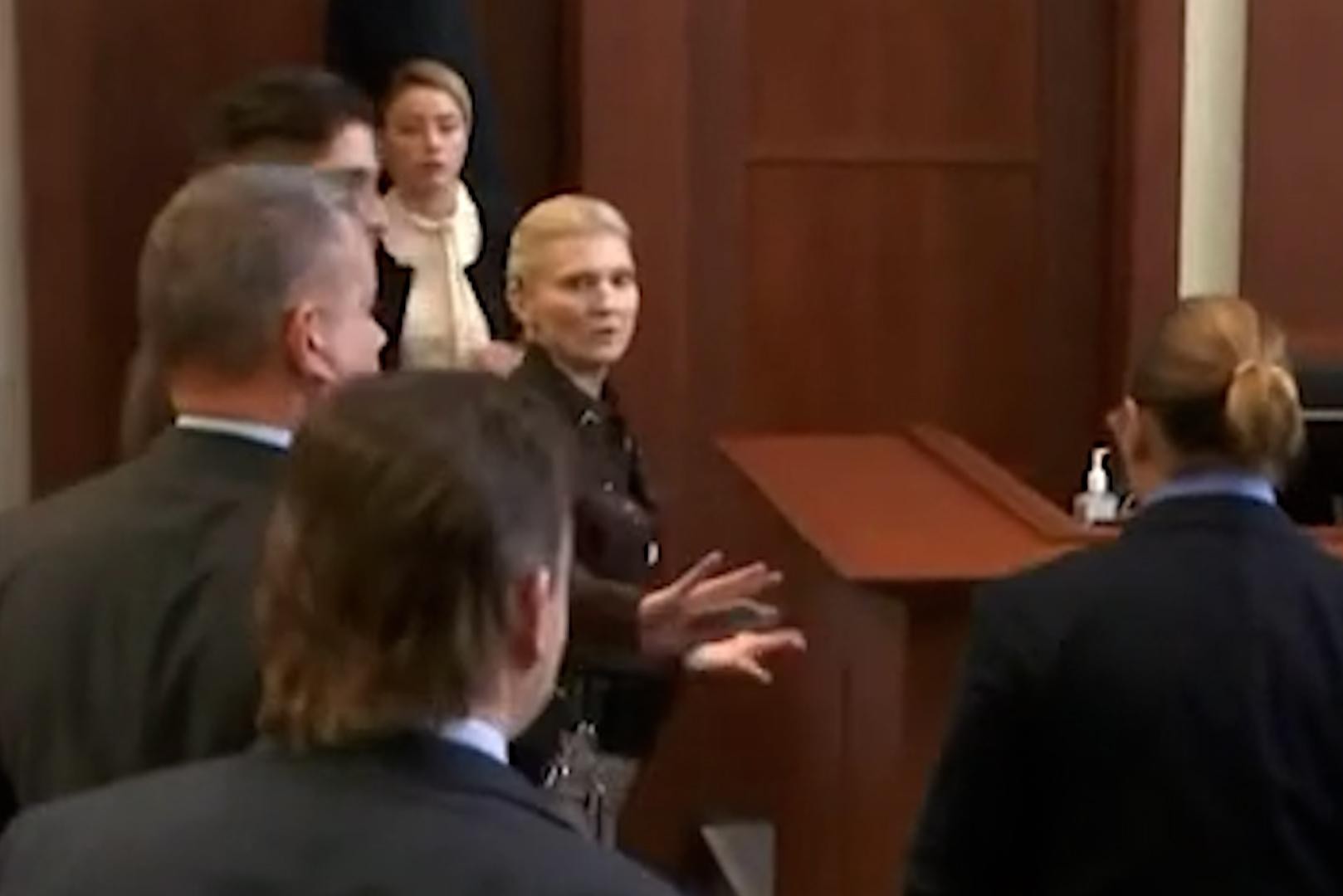 Striking moment in the courtroom: Amber Heard recoils as Johnny Depp walks in her direction